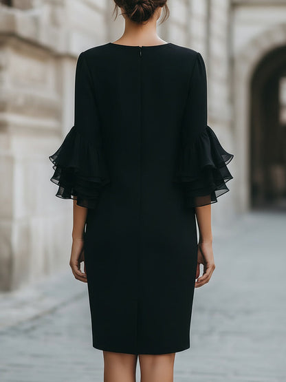 Vestito nero con maniche trasparenti a volant