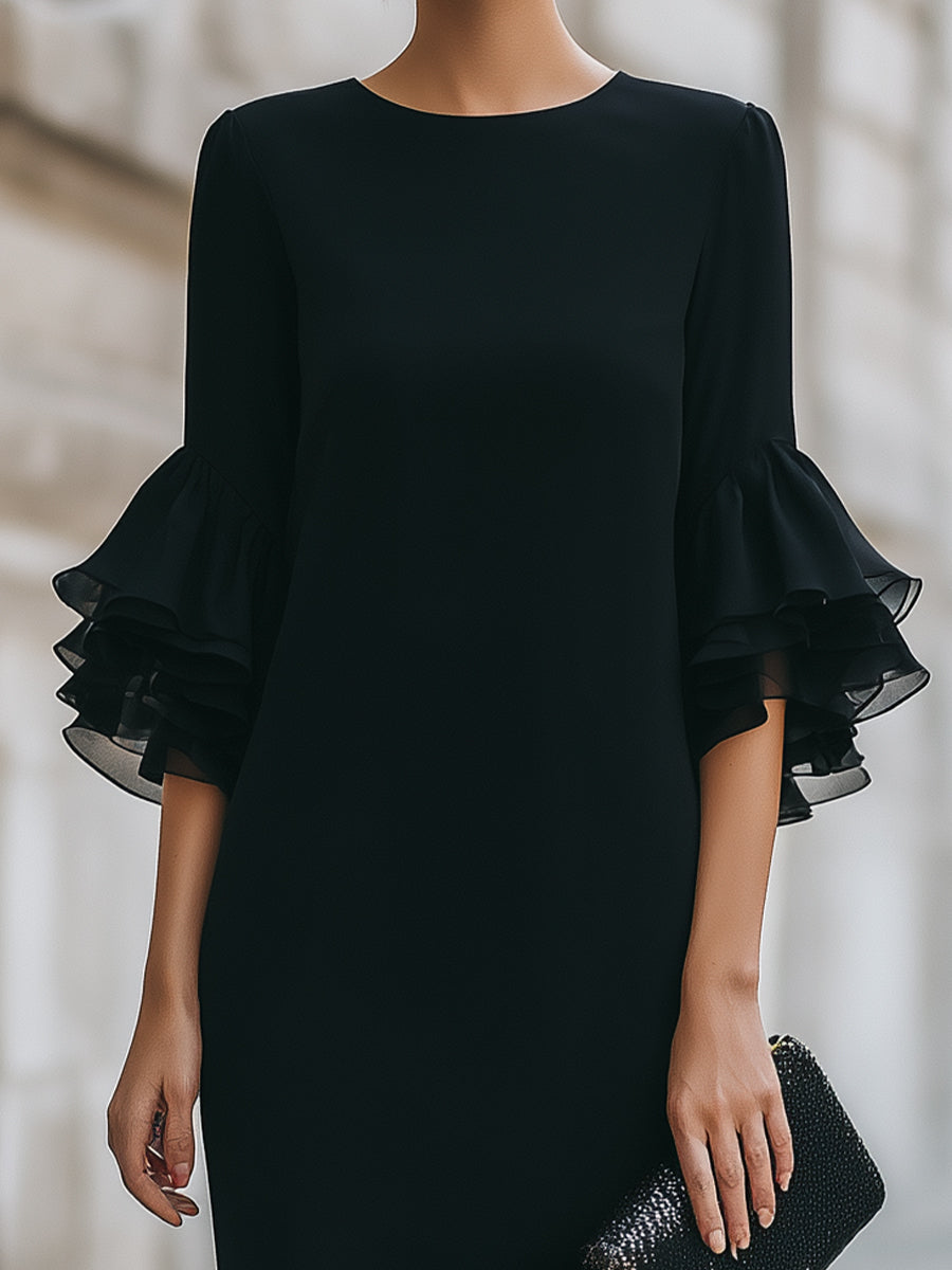 Vestito nero con maniche trasparenti a volant