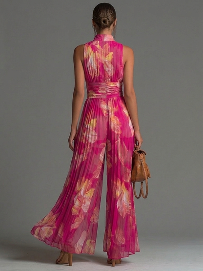 Tuta in chiffon plissettata con stampa floreale fucsia, senza maniche, con cerniera, a gamba ampia